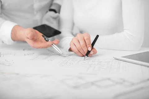 Engineers are conferring on project drawings. Stock Photos