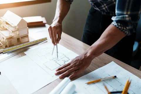 Engineers are designing house structures and architectural using blueprints Stock Photos