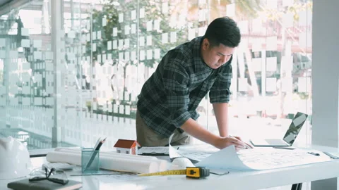 Engineers are designing working on blueprints and analyzing the structure of  Stock Footage 167246606
