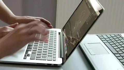 Engineers are discussing of graphs on one laptop Stock-Footage 70018647
