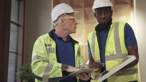 Engineers are discussing how to install solar panels on the building Stock Footage 154874885