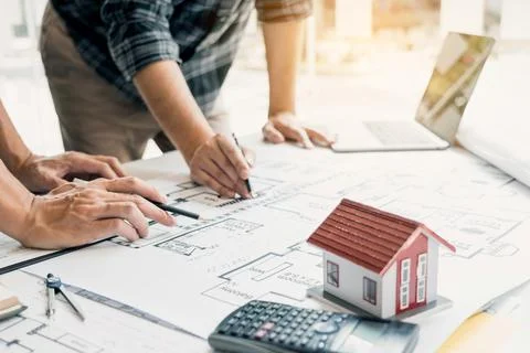 Engineers are helping to design work on blueprints and collaborate on struc.. Stock Photos