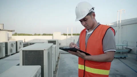 Engineers are inspecting the air conditioning system on the roof deck of the  Stock Footage 217963227