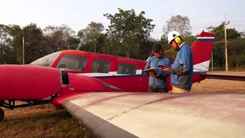 Engineers are investigating the small plane with a tablet Stock Footage 147142242