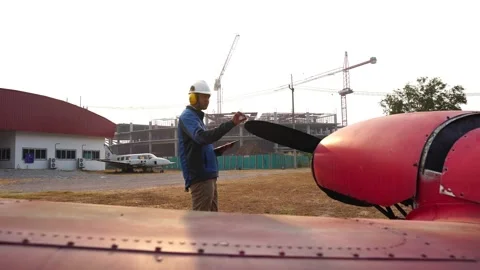 Engineers are investigating the small plane with a tablet Stock Footage 147145069