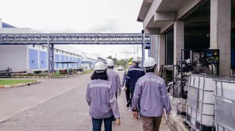 Engineers are walking through industry manufacturing factory, Safety patrol i Stock Photos