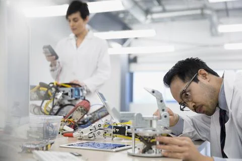 Engineers assembling robotics in factory Stock Photos