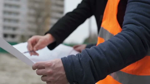 Engineers builders at the construction site reviewing the drawings Stock Footage 88646527