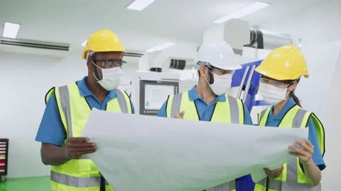 Engineers care of healthy working, looking drawing and explaining job. Stock Footage 147911186