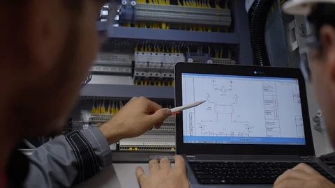 Engineers check electrical status of machine device on the monitor Stock Footage 101944941