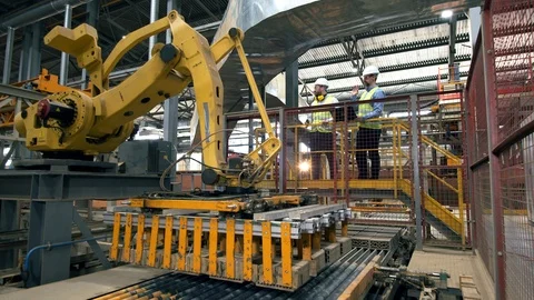 Engineers check a working machine at a brick factory. Factory male engineers in Video stock 119169234