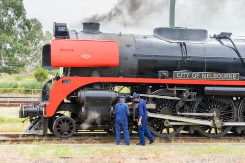 Engineers checking the engine of steam locomotive Photos