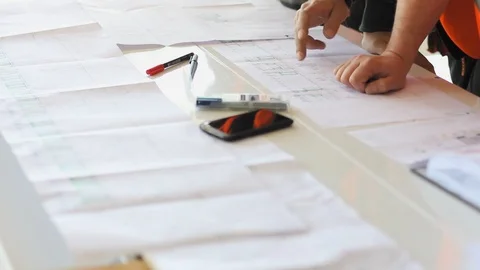 Engineers checking measures in architectural sketches. Stock Footage 99973044