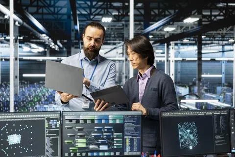 Engineers coding in data center, updating AI driven automation scripts Stock Photos