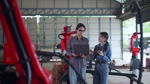 Engineers Collaborating with Laptop in Industrial Workshop Stock Footage 282519548