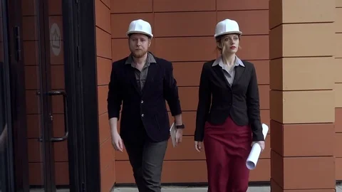 Engineers in construction helmets on the construction site. Architects young Stock Footage 75366990