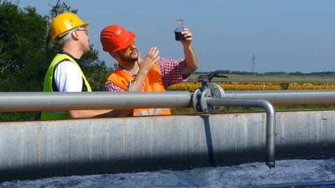 Engineers controlling a quality of water Stock Footage 125080183