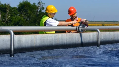 Engineers controlling a quality of water Stock Footage 125080357