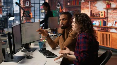 Engineers cooperating in startup office, using programming languages on PC 스톡 사진