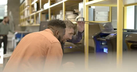 Engineers in creative office looking at 3d printer and model Stock Footage 165081074