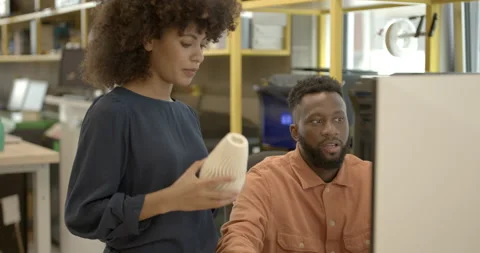 Engineers in creative office looking at 3d printer and model Stock Footage 165081713