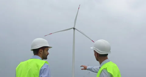 Engineers discuss wind turbine generating energy on farm Stock-Footage 160816743