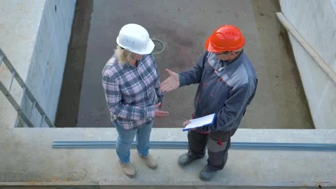 Engineers discussing and shaking hands at construction site Stock Footage 315414417