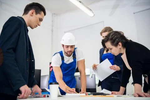 Engineers discussing the efficiency of the construction plan in their office Stock Photos