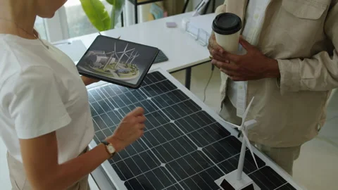 Engineers Discussing Implementation of Wind and Solar Power Sources in Business Stock Footage 276885292