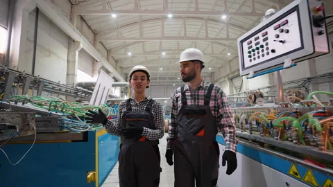 Engineers discussing production process in modern factory Stock Footage 314584136