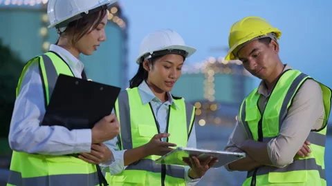 Engineers discussing project plans at construction site Stock Footage 297779552