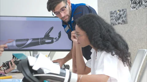 Engineers, doctors and physical therapists brainstorm ideas to design a robot Stock Footage 274692691