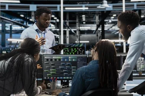 Engineers doing brainstorming, programming in server farm 写真素材