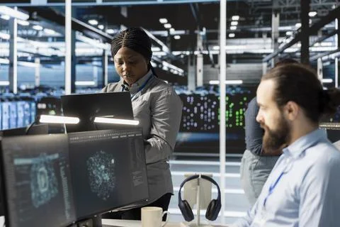 Engineers doing maintenance on blade servers supplying compute power Stock Photos