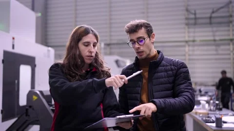 Engineers doing paperwork and organizing a cnc factory Stock Footage 262107867