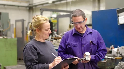 Engineers during a quality control of pieces in a factory Stock Footage 258397653