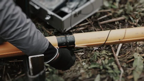 An engineers gloved hands inspecting a plastic gas pipe connection for defects. Stock Footage 318267844