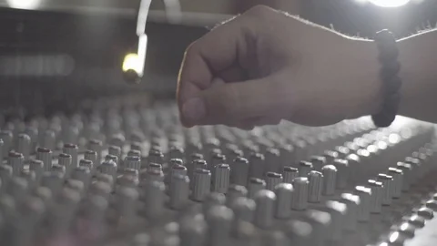 An engineers hand adjusting a potentiometer on a sound mixer, camera truck right Stock Footage 89835525