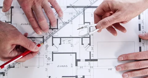 Engineers hands draw building plan with ruler and dividers Stockbeeldmateriaal 243831849