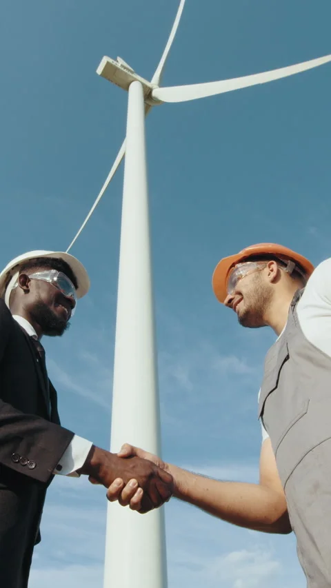 Engineers Handshake by Wind Turbine Stock Footage 318629244