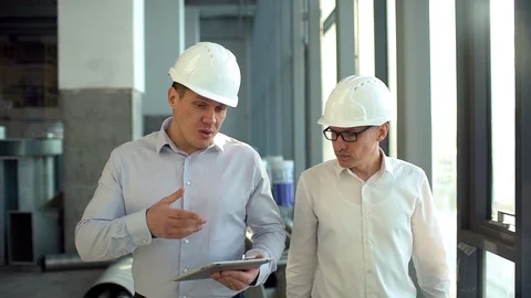 Engineers Have Conversation and using Tablet Computer on Construction Site. slow Stock Footage 85885717