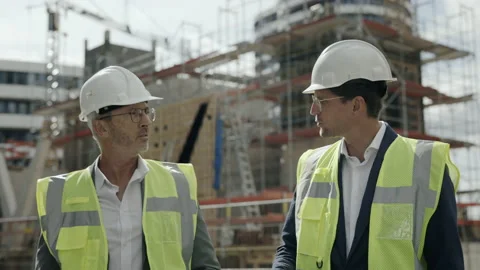 Engineers in helmet talking and walking on construction site Stock-Footage 167024361
