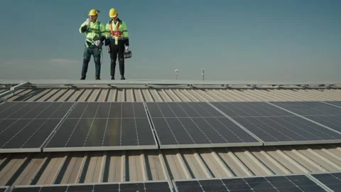 Engineers in helmets installing solar panel Stock Footage 282957742