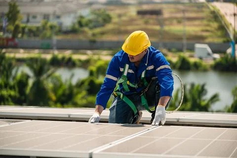 Engineers in helmets installing solar panel Foto stock