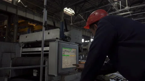 Engineers in helmets work with the control panel at the plant. Stock Footage 86196180