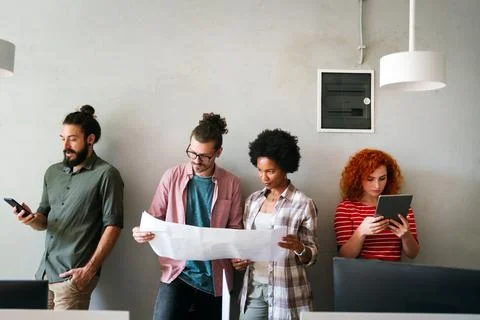 Engineers helping design work on blueprints, collaborate on structural anal.. Stock Photos