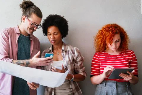 Engineers helping design work on blueprints, collaborate on structural anal.. Stock Photos