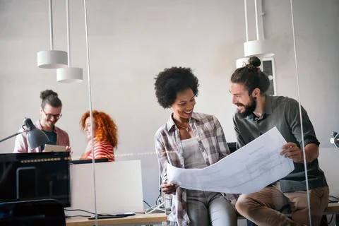Engineers helping design work on blueprints, collaborate on structural anal.. Stock Photos