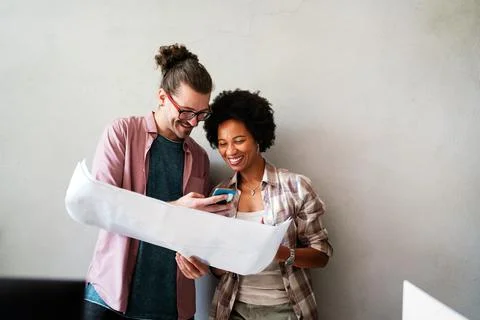 Engineers helping design work on blueprints, collaborate on structural anal.. Stock Photos