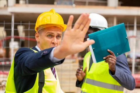 Engineers hiding their faces in front of camera Stock Photos